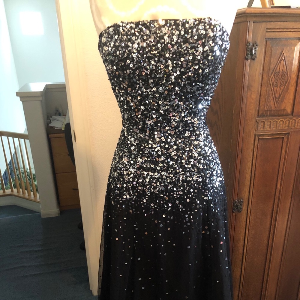 Black strapless lined cocktail dress, size small.